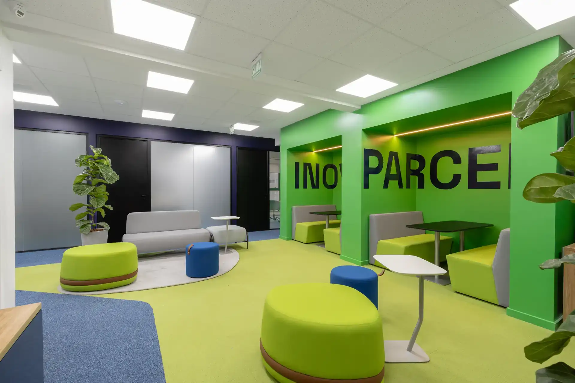 Espaço colaborativo verde da Transit BR com bancadas e booths integrados, mostrando soluções de projeto de arquitetura e reforma corporativa voltadas para bem estar e interação da equipe.